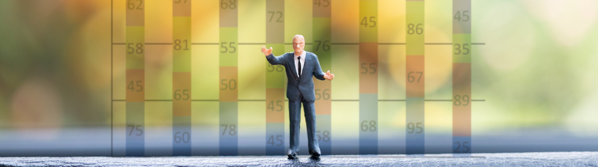 vecteezy_miniature-businessman-standing-in-front-of-a-graph-chart_2155852-2
